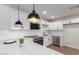 Modern kitchen featuring white cabinets, stainless steel appliances, and pendant lighting at 1649 W Carmel Ave, Mesa, AZ 85202