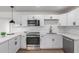 Well-equipped kitchen featuring stainless steel appliances and white cabinets at 1649 W Carmel Ave, Mesa, AZ 85202