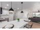 Bright kitchen with a quartz countertop island and stainless steel appliances at 1649 W Carmel Ave, Mesa, AZ 85202