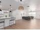 Open-concept living space with kitchen view, pendant lighting, and modern decor at 1649 W Carmel Ave, Mesa, AZ 85202