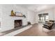 Cozy living room with a brick fireplace and natural light from sliding doors to the outdoor space at 1649 W Carmel Ave, Mesa, AZ 85202