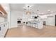 Open floor plan features custom built-ins, fireplace, and kitchen island with bar stools at 1649 W Carmel Ave, Mesa, AZ 85202