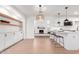 Open floor plan boasts custom built-ins, fireplace, and kitchen with bar seating at 1649 W Carmel Ave, Mesa, AZ 85202