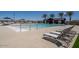 Relaxing community pool area featuring lounge chairs, shade umbrellas and pristine landscaping at 17608 W Georgia Ave, Litchfield Park, AZ 85340