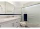 Clean bathroom with a white vanity, new mirror, and frosted glass shower doors at 1825 S Spruce --, Mesa, AZ 85210
