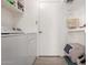 Laundry room with a white washer and dryer and built-in shelves for storage at 1825 S Spruce --, Mesa, AZ 85210