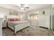 Bright primary bedroom with large window, ceiling fan, and stylish area rug at 1825 S Spruce --, Mesa, AZ 85210
