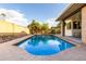 Backyard swimming pool surrounded by a patio and rock landscaping, enclosed by a tall brick wall at 1825 S Spruce --, Mesa, AZ 85210