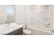 Well-lit bathroom featuring a modern vanity, sink, and bathtub with shower at 18716 N 269Th Ln, Buckeye, AZ 85396