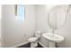 Half bathroom featuring a modern sink, toilet, and minimalist design at 18716 N 269Th Ln, Buckeye, AZ 85396