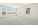 Bright bedroom with large windows offering scenic desert views and plush gray carpeting at 18716 N 269Th Ln, Buckeye, AZ 85396