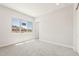 Bright bedroom with neutral carpet and a large window overlooking a mountain view at 18716 N 269Th Ln, Buckeye, AZ 85396