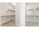 Large walk-in closet with built-in shelving and ample space for clothing and storage at 18716 N 269Th Ln, Buckeye, AZ 85396