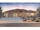 Stunning single-story home featuring a three car garage and desert landscaping at 18716 N 269Th Ln, Buckeye, AZ 85396