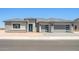 Contemporary home featuring a three-car garage, modern door, and stone accents at 18716 N 269Th Ln, Buckeye, AZ 85396