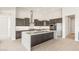 This kitchen features dark wood cabinets, a large island, and stainless steel appliances at 18716 N 269Th Ln, Buckeye, AZ 85396
