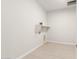 Dedicated laundry room with tile floors, modern hookups, and a convenient storage shelf at 18716 N 269Th Ln, Buckeye, AZ 85396