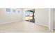 Bright open living area with tile floors and access to a patio with desert view at 18716 N 269Th Ln, Buckeye, AZ 85396
