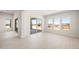 Bright living room boasts tile flooring, recessed lighting, and desert views from many windows at 18716 N 269Th Ln, Buckeye, AZ 85396