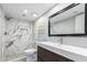 Updated bathroom features large mirror, modern vanity, and sleek, glass-enclosed shower at 1880 E Morten Ave # 242, Phoenix, AZ 85020