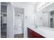 Bathroom features a red-wood vanity with white sink and shower with glass door at 1880 E Morten Ave # 242, Phoenix, AZ 85020