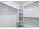 A spacious closet with shelves and wooden clothing rods for lots of storage at 1880 E Morten Ave # 242, Phoenix, AZ 85020