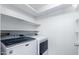 Convenient laundry room with a newer model, front-load washer and dryer and shelving at 1880 E Morten Ave # 242, Phoenix, AZ 85020