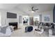Bright living room featuring a fireplace, ceiling fan, and sliding glass door to patio at 1880 E Morten Ave # 242, Phoenix, AZ 85020
