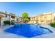 Community pool surrounded by well-maintained landscaping and lounge chairs at 1880 E Morten Ave # 242, Phoenix, AZ 85020