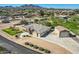 Spacious home with pristine landscaping, a detached garage, and a circular driveway with an inspiring mountain backdrop at 19535 E Via De Olivos Rd, Queen Creek, AZ 85142