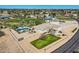 Aerial view of the beautiful property featuring a sparkling pool, playground, manicured lawn, and convenient circle driveway at 19535 E Via De Olivos Rd, Queen Creek, AZ 85142