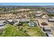 Expansive property featuring a refreshing pool, spa, and covered lounge area with spacious green lawns and scenic desert landscape at 19535 E Via De Olivos Rd, Queen Creek, AZ 85142