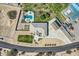 Luxurious home featuring a pristine pool, spa, and multiple garages surrounded by manicured lawns and a paved driveway at 19535 E Via De Olivos Rd, Queen Creek, AZ 85142