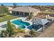 Aerial view of home with pool, spa, covered patio, lush landscaping, and a fully fenced yard, perfect for outdoor living at 19535 E Via De Olivos Rd, Queen Creek, AZ 85142