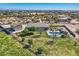 Expansive property featuring a refreshing pool, spa, and covered lounge area with spacious green lawns and scenic desert landscape at 19535 E Via De Olivos Rd, Queen Creek, AZ 85142