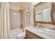 Stylish bathroom with tub shower combo, marble vanity, and neutral color palette at 19535 E Via De Olivos Rd, Queen Creek, AZ 85142