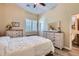 Cozy bedroom features white-washed wood furniture, a decorative quilt, and en-suite bath at 19535 E Via De Olivos Rd, Queen Creek, AZ 85142