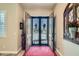 Gorgeous foyer with tile floors and view of custom iron front door at 19535 E Via De Olivos Rd, Queen Creek, AZ 85142