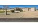 Stunning front exterior with well maintained desert landscaping and neutral colored stucco at 19535 E Via De Olivos Rd, Queen Creek, AZ 85142