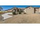 Stunning front exterior with well maintained desert landscaping and neutral colored stucco at 19535 E Via De Olivos Rd, Queen Creek, AZ 85142