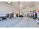 Spacious garage with ample storage, overhead lighting, and room for multiple vehicles and recreational equipment at 19535 E Via De Olivos Rd, Queen Creek, AZ 85142