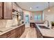 A beautifully designed kitchen featuring wood cabinets, stainless steel appliances, and a marble countertop at 19535 E Via De Olivos Rd, Queen Creek, AZ 85142