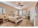 A serene bedroom featuring a large bed, shuttered windows, and neutral decor at 19535 E Via De Olivos Rd, Queen Creek, AZ 85142