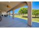 Expansive covered patio offers shade and views of the lush yard, perfect for relaxing and entertaining at 19535 E Via De Olivos Rd, Queen Creek, AZ 85142