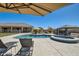 Backyard oasis with pool, spa, covered dining area, and lounge chairs perfect for relaxation and entertaining at 19535 E Via De Olivos Rd, Queen Creek, AZ 85142