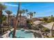 Aerial view of a community pool with palm trees and apartment buildings at 2025 E Campbell Ave # 114, Phoenix, AZ 85016