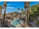 Aerial view of a community pool area, surrounded by palm trees and buildings at 2025 E Campbell Ave # 114, Phoenix, AZ 85016