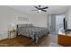 Bedroom featuring dark wood floors, a ceiling fan, and a sliding glass door to a balcony at 2025 E Campbell Ave # 114, Phoenix, AZ 85016