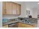 Kitchen featuring stainless steel dishwasher, granite countertops and light wood cabinets at 2025 E Campbell Ave # 114, Phoenix, AZ 85016