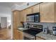 Galley kitchen featuring stainless steel appliances and light wood cabinetry with granite countertops at 2025 E Campbell Ave # 114, Phoenix, AZ 85016